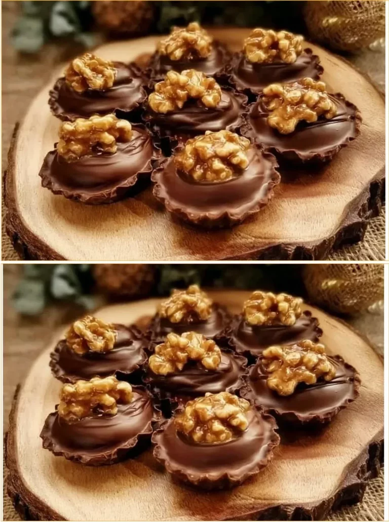 Linz orechové cupcakes s čokoládovým frostingom na bielom tanieri